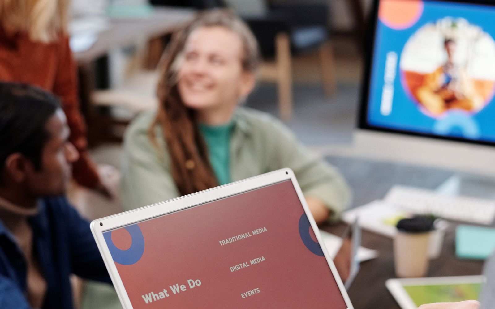 Marketing team reviewing campaign plans on a laptop