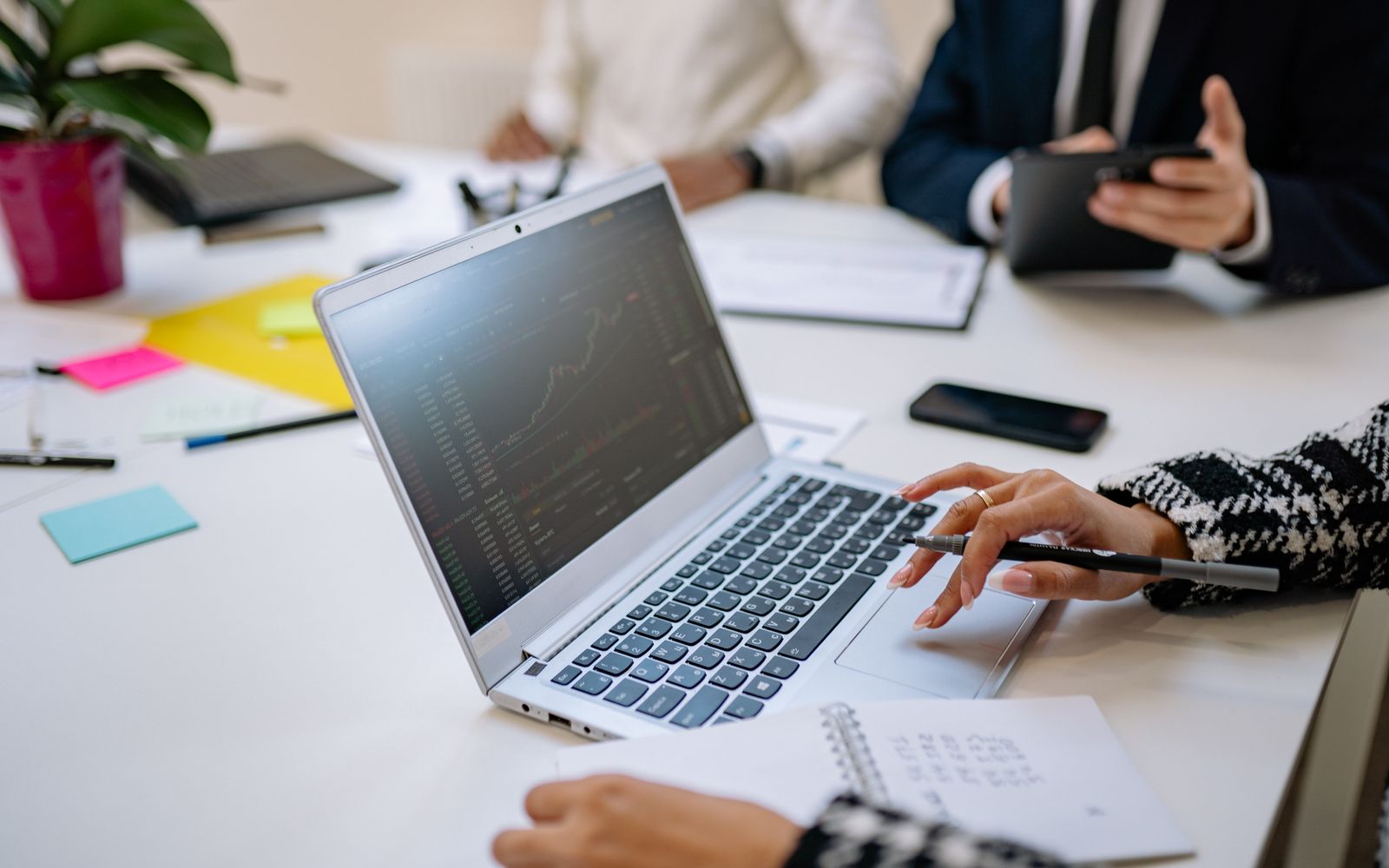 Professionals analyzing business data on a laptop during a meeting