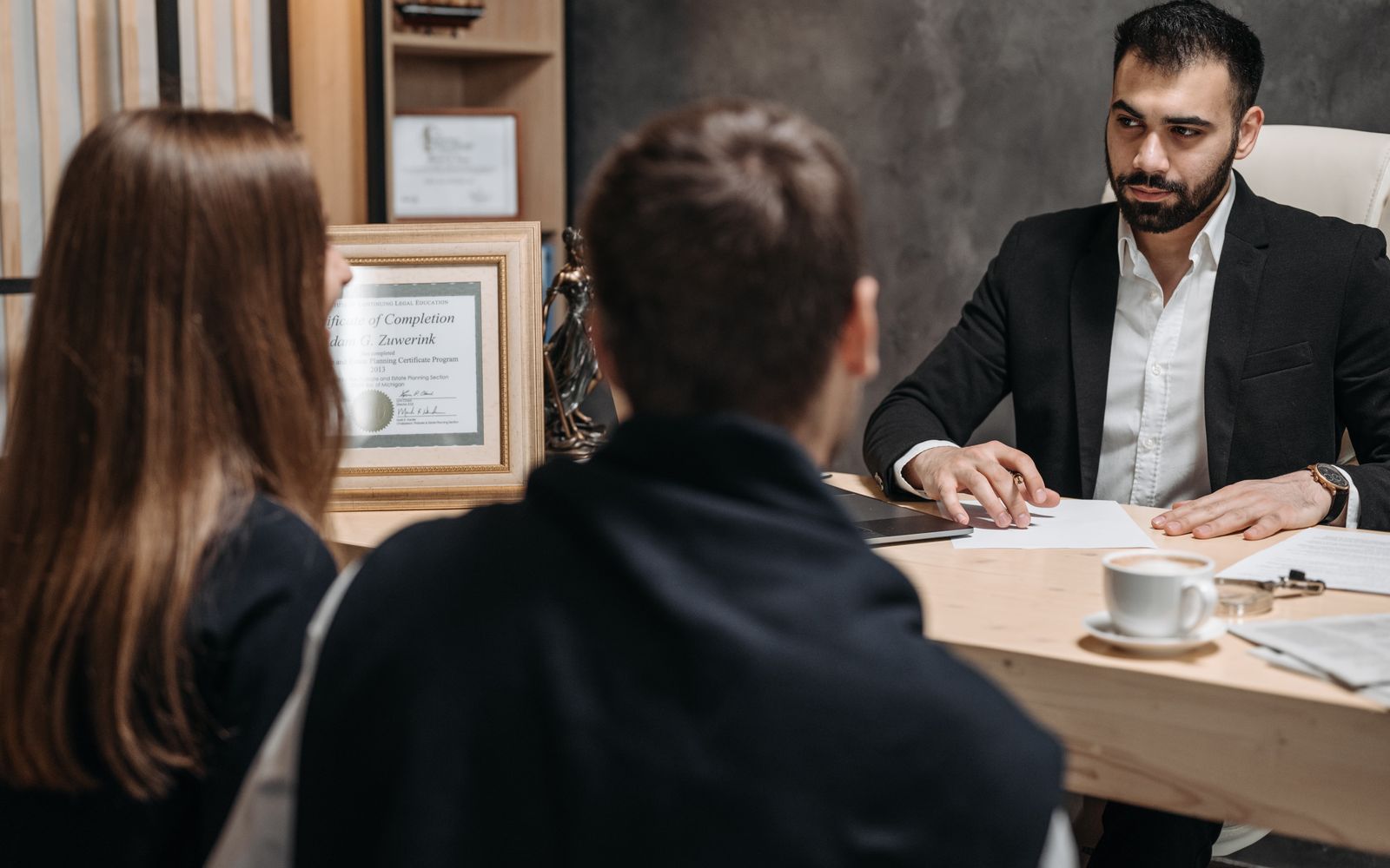 Lawyer discussing documents with clients in an office